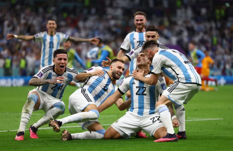 Argentinian+players+celebrate+their+penalty+shootout+victory+over+the+Netherlands+at+Lusail+Iconic+Stadium%2C+Qatar+%5BKai+Pfaffenbach%2FReuters%5D
